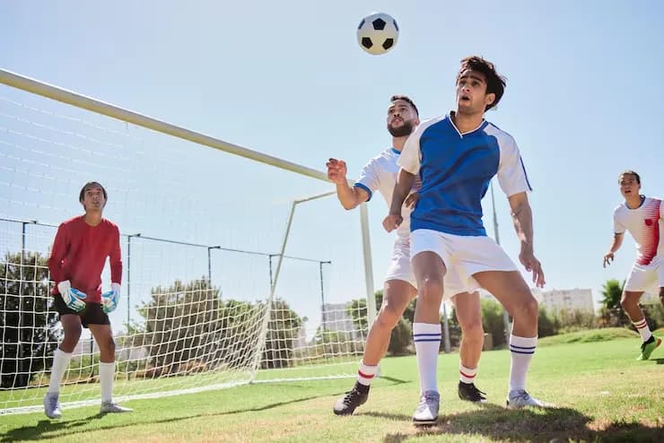 Players challenging for the ball during a match
